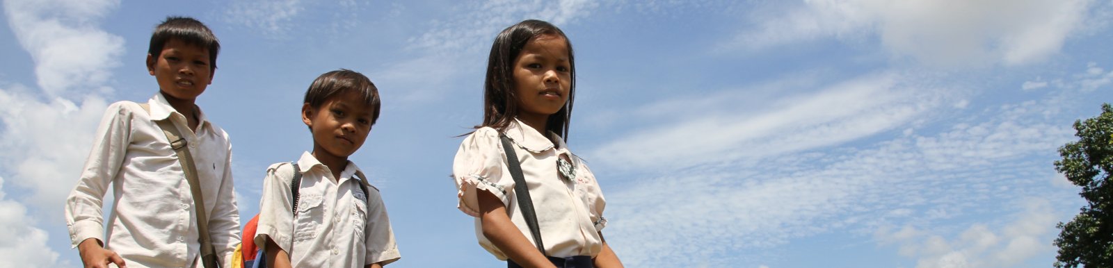 Srey Yeng, 8-year old girl, walking to school with her brothers.
